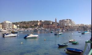 a bunch of boats in the water in a harbor at The April Maisonette in Marsaskala