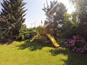 a playground in a yard with a slide at Rebel House in Frýdlant nad Ostravicí