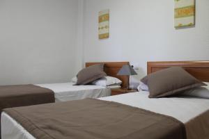 Cama o camas de una habitación en Apartamentos Turisticos Caños de Meca