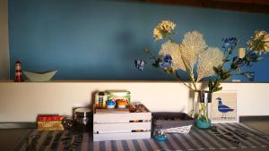 a table with a vase with a flower in it at Ca' Le Erbe in Fano