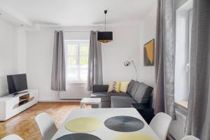 a living room with a couch and a table at Evva & Peppe Old Town Flat in Warsaw