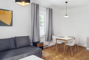 a living room with a couch and a table at Evva & Peppe Old Town Flat in Warsaw
