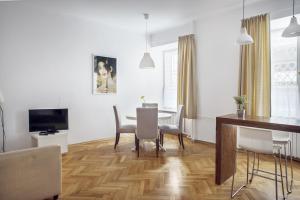 a living room with a dining room table and chairs at Bednarska Old Town Apartment in Warsaw