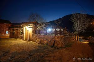 a stone building with a light on it at night at Casa de Aldea Ecocorneyana in Campomanes
