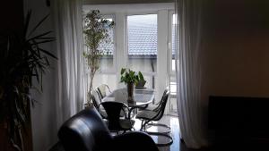 a table and chairs in a room with a window at Vilnius Luxury Apartment 1 in Vilnius
