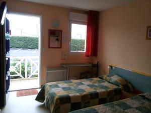 Postel nebo postele na pokoji v ubytování Tour Hôtel