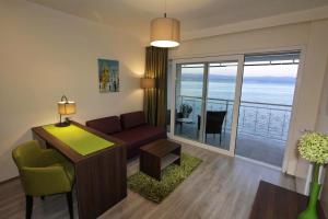 a living room with a couch and a table at Hotel Stanger in Lovran