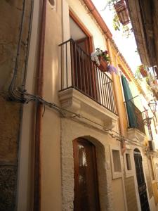 a building with a balcony and a door at Al Blu Ortigia Apartments in Syracuse