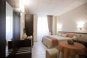 a hotel room with a bed and a table at Domus Palatina in Rome