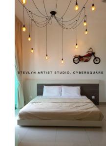 a bedroom with a bed with a motorcycle on the wall at Stevlyn Artist Studio in Cyberjaya