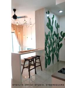 a kitchen with a cactus painting on the wall at Stevlyn Artist Studio in Cyberjaya