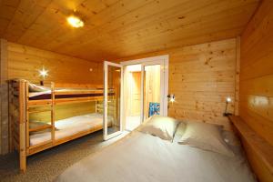 a bedroom with two bunk beds in a log cabin at Villa Lodge Natureo in Seignosse +16 photos