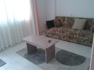 a living room with a couch and a coffee table at Aygun Apartment 2 in Mahmutlar