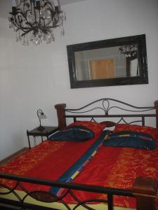 a bedroom with two beds with a mirror and a chandelier at Ferienwohnung Westend-Grunewald in Berlin