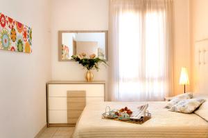 a bedroom with a bed with a tray of food on it at Residence Teclini in Castiglione della Pescaia