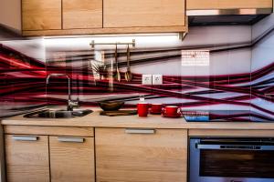 a kitchen with a sink and a colorful wall at Apartments BBI in Luče