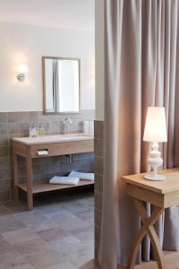 a bathroom with a sink and a mirror at Genießerhotel Döllerer in Golling an der Salzach