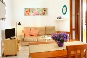 a living room with a couch and a table at Residence Teclini in Castiglione della Pescaia