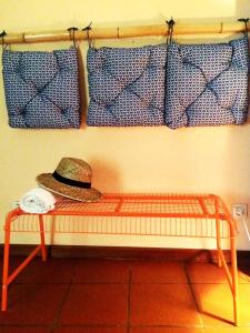 a hat sitting on a bench in a room at Out of Town in Castelo de Paiva