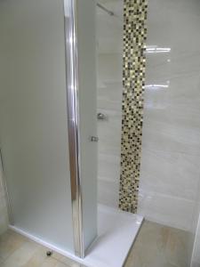 La salle de bains est pourvue d'une douche avec une porte en verre. dans l'établissement Ferienwohnung Brinkmann, à Hohen Wieschendorf