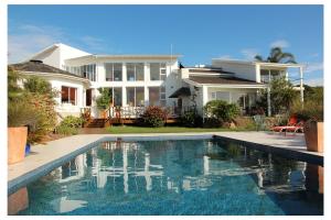 een huis met een zwembad voor een huis bij Cintsa Lodge in Chintsa