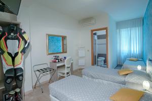 a bedroom with two beds and a desk with a table at Locanda San Biagio in Misano Adriatico +34 photos