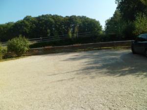 a parking lot with a car parked in it at le paradis vert in Pirajoux