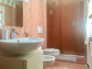 a bathroom with a sink and a toilet at B&B Griffoni 7 in Bologna +36 photos