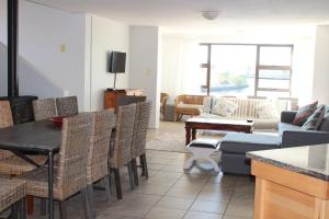 a living room with a table and chairs and a couch at Port Owen Self Catering in Velddrif