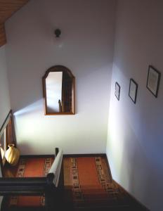 a stairway with a mirror and a stair case at Apartments Janjusevic in Bled