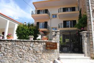 a building with a gate and a stone wall at Filoxenia in Levidi