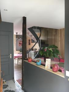 a living room with a mirror on a shelf at L'ANNEXE in Carennac