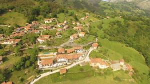 a small town with houses and trees at Puebloastur Eco Resort Hotel & Spa in Cofiño