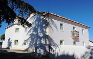 a large white building with a tree in front of it at Tapada da Rabela - Reserva Natural in Marvão