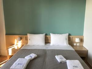 a bedroom with a bed with two towels on it at Kleanthi Studios in Chania