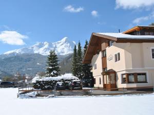 a building with a snow covered mountain in the background at Apart Tyrolis in Sölden