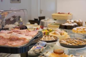 a table filled with different types of pastries and desserts at Hotel La Meridiana in Sorrento
