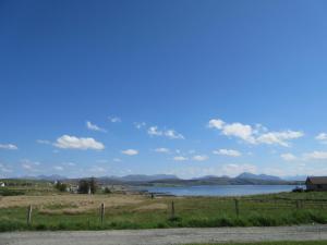 a view of a lake with mountains in the background at Taighali Apartment in Aultbea