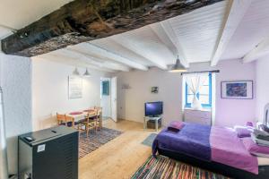 a bedroom with a bed and a table and chairs at Apartments Galerija Motovun in Motovun