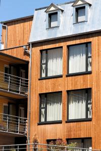 an orange building with white curtains in the windows at Hôtel De L'Ill in Strasbourg +40 photos