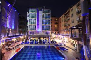 an indoor pool in front of a hotel at night at Tac Premier Hotel & Spa in Alanya