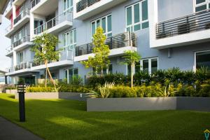 an apartment building with a green lawn in front of it at HomestayIpoh-Octagon in Ipoh