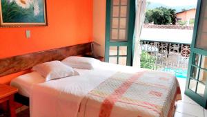 Giường trong phòng chung tại Pousada Villa Harmonia