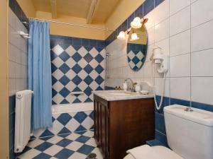 a bathroom with a toilet and a sink at Villa De Loulia in Peroulades
