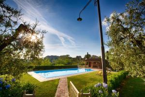 a swimming pool in the yard of a house at Podere Sant'Antonio in Fauglia +56 photos