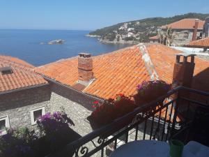 a view of the roofs of buildings and the water at Apartments Debora in Ulcinj