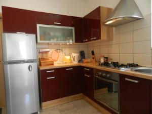 a kitchen with brown cabinets and a stainless steel refrigerator at Apartment Eli in Lumbarda