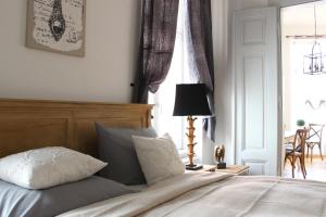 a bedroom with a bed and a lamp and a window at Leon Apartments in Leipzig