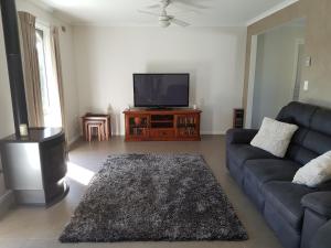 a living room with a couch and a flat screen tv at Kings Cottage in Paynesville