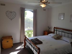 a bedroom with a bed and a large window at Kings Cottage in Paynesville